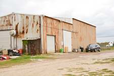 Front view of metal building with large access doors on property located on IH 35 West Side Frontage Road, Dilley, TX
