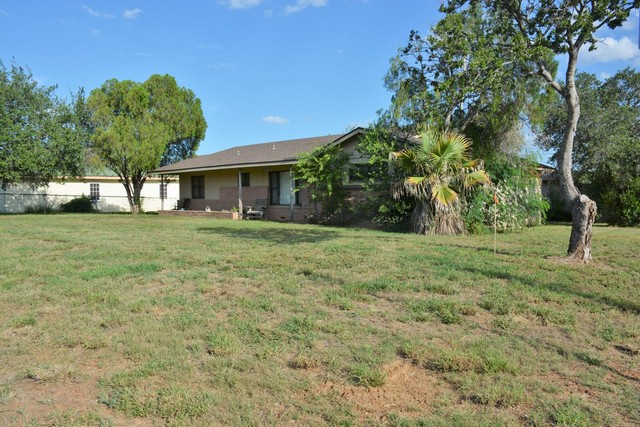 Front view of frame residential house located at 1005 Houston St., Cotulla, TX