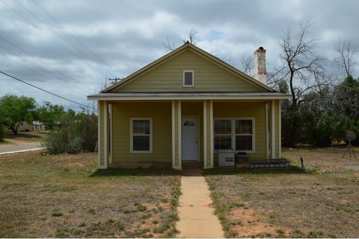 Front view of wood frame residential house located at 903 Live Oak, Cotulla, TX