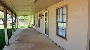 Back porch of wood frame residential house located at 903 Live Oak, Cotulla, TX