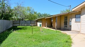 Backyard of wood frame residential house located at 903 Live Oak, Cotulla, TX