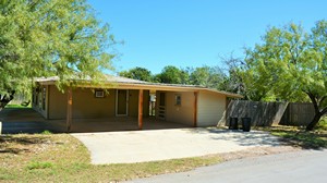 Carport view of wood frame residential house located at 903 Live Oak, Cotulla, TX
